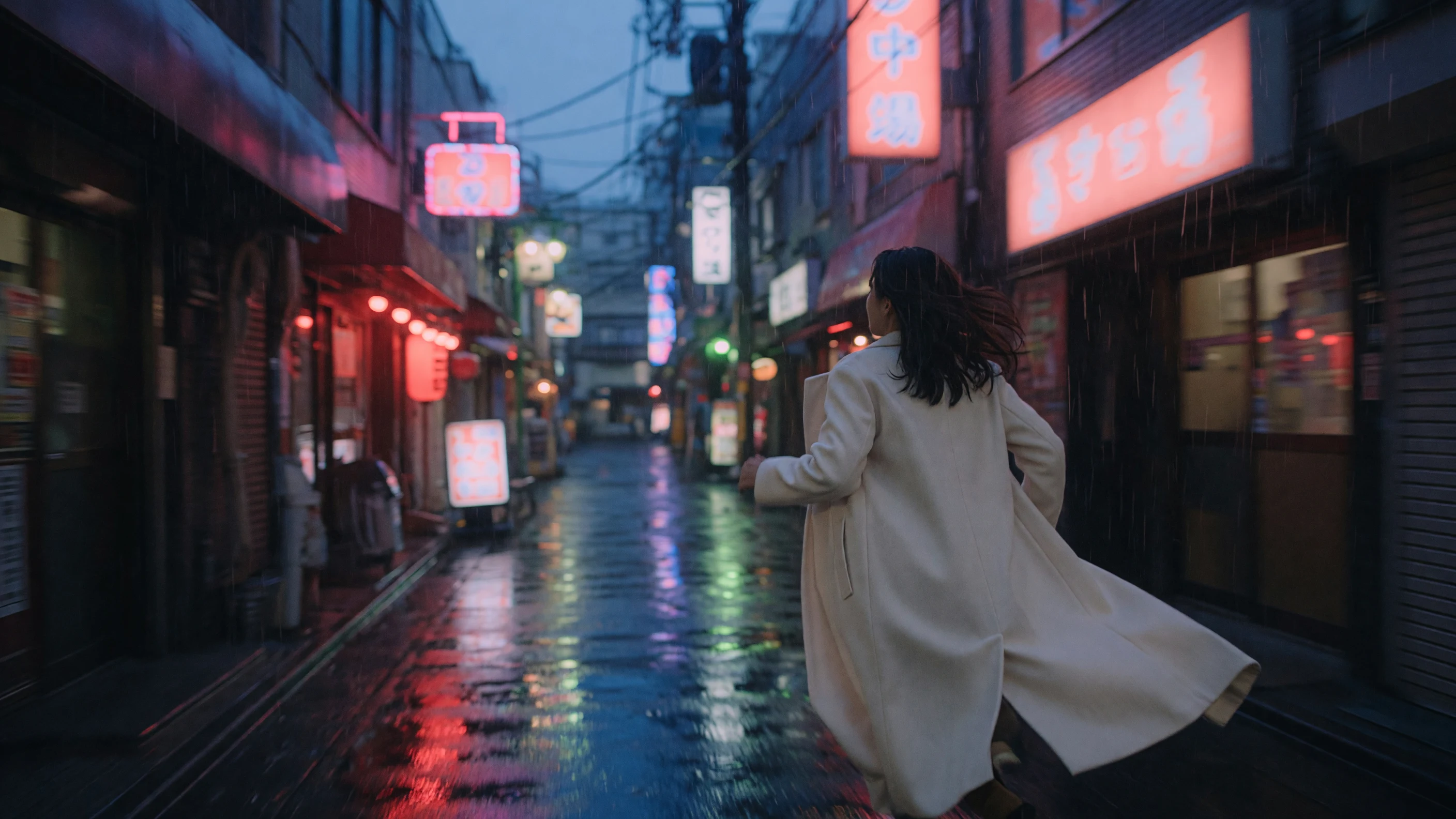 Cinematic inspiration: a woman walking through a rain-lit alley